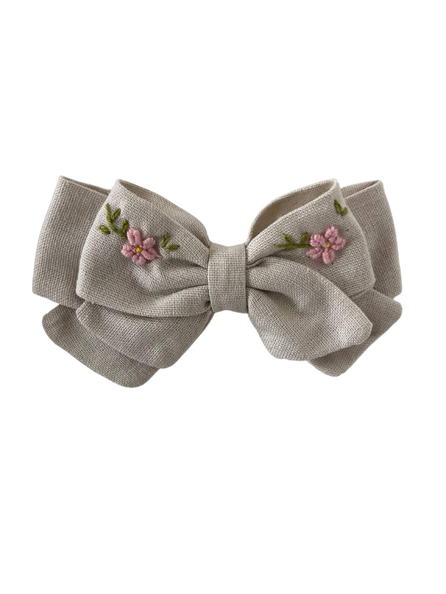 Moño de lino beige bordado a mano en tonos rosa pastel,